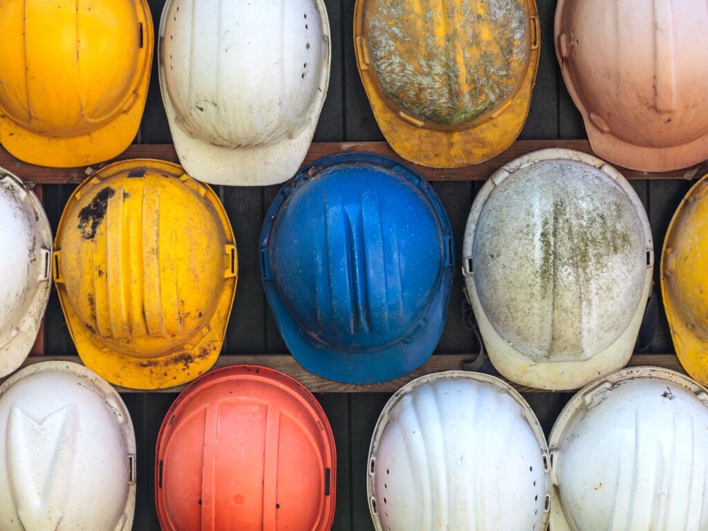 Hardhats hanging on a wall for OSHA compliance